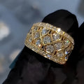 Gold copper ring with geometric quadrilateral hollow-out design and diamond inlay on white background