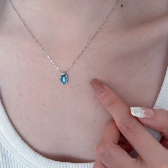 Women's navy blue water drop necklace with geometric pendant on adjustable cross chain