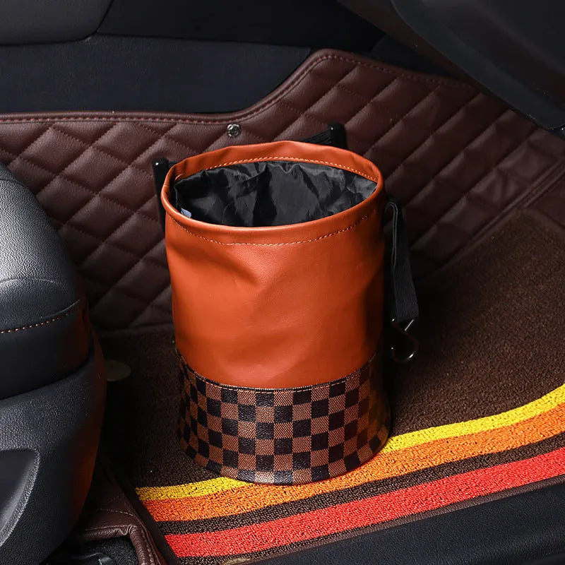 Retractable leather car bin showing folding design with carry handle for vehicle waste management
