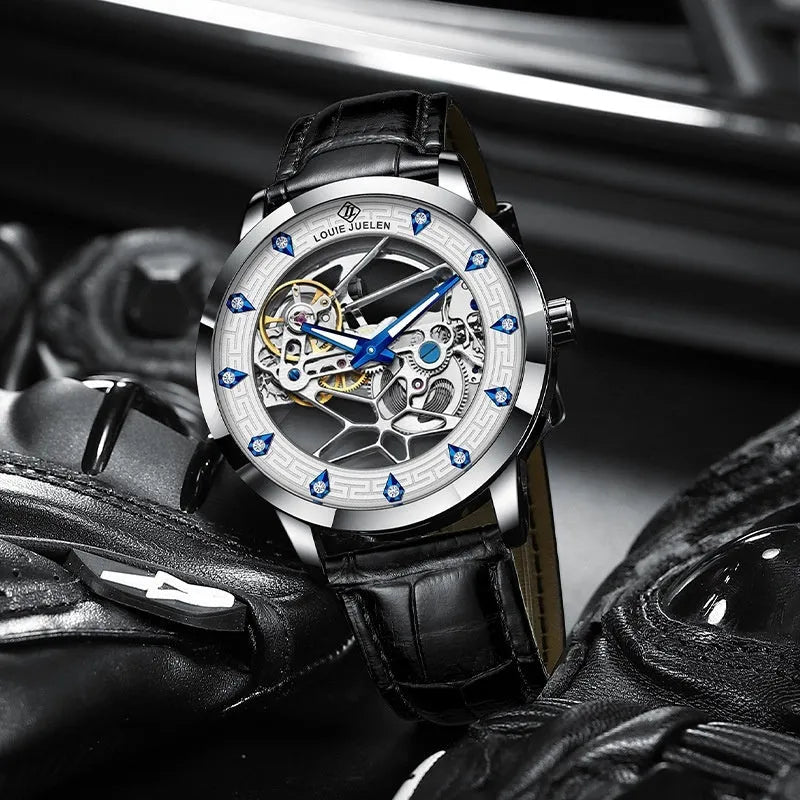 Men's silver case mechanical watch with white dial, blue hands, black leather strap, and butterfly buckle