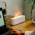 Square creative lava flame desktop humidifier and aroma diffuser in black or white colour on a desk.