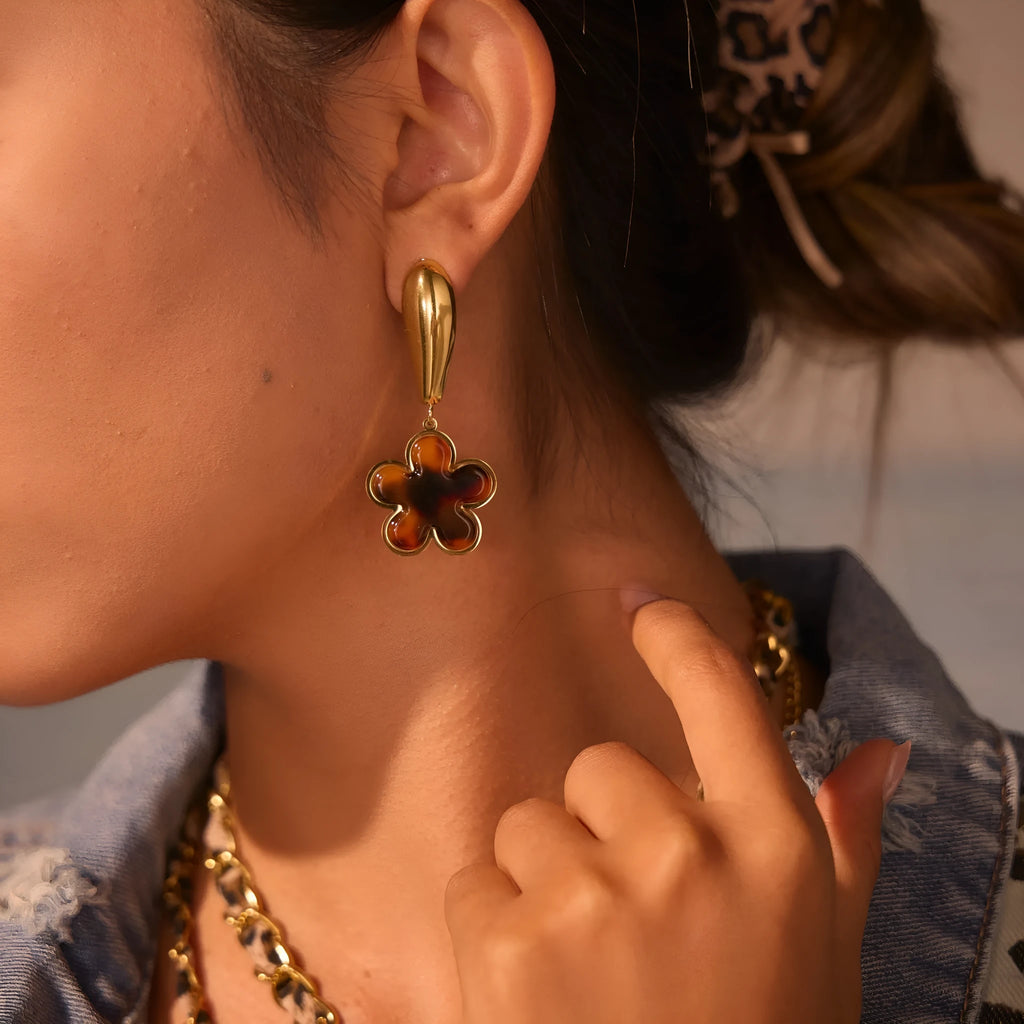 Gold electroplated tortoiseshell resin earrings in heart and flower designs on stainless steel