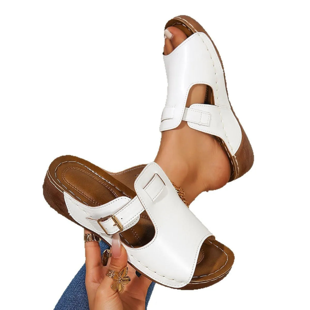 White women's casual magic stick slippers with a fish mouth toe on a light background