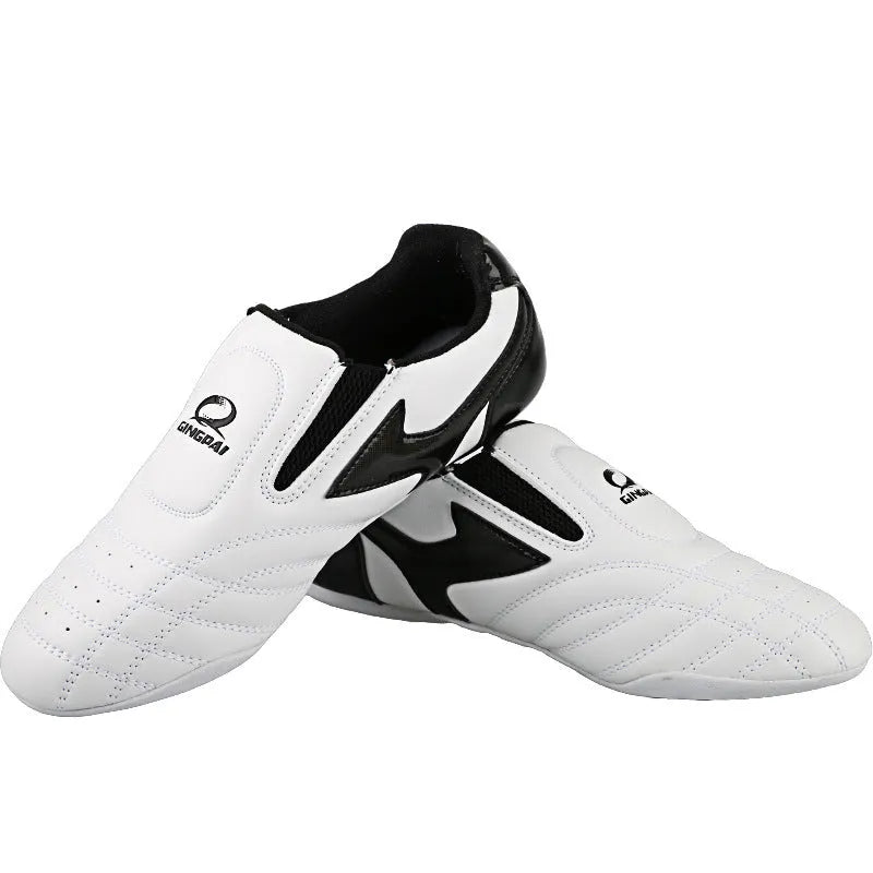 Black and white children's martial arts training shoes with soft bottom construction and widened design