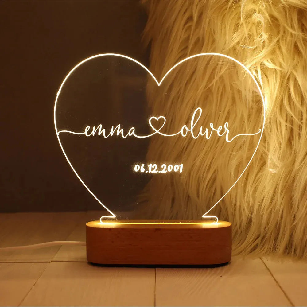Personalised acrylic night light with engraved names and date, measuring 20cm by 11.5cm