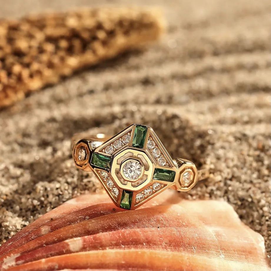 Geometric square emerald diamond ring in lvzuan colour on a model's hand.