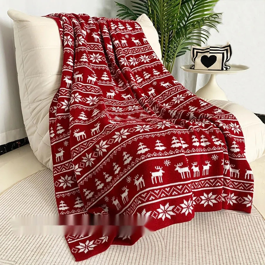 Personalised Christmas blanket with cartoon reindeer pattern, folded to show its soft acrylic texture.