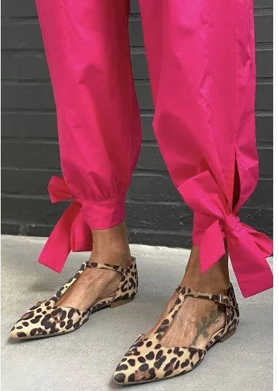 Leopard print women's pointed toe pumps with a chunky low heel and a cross ankle strap