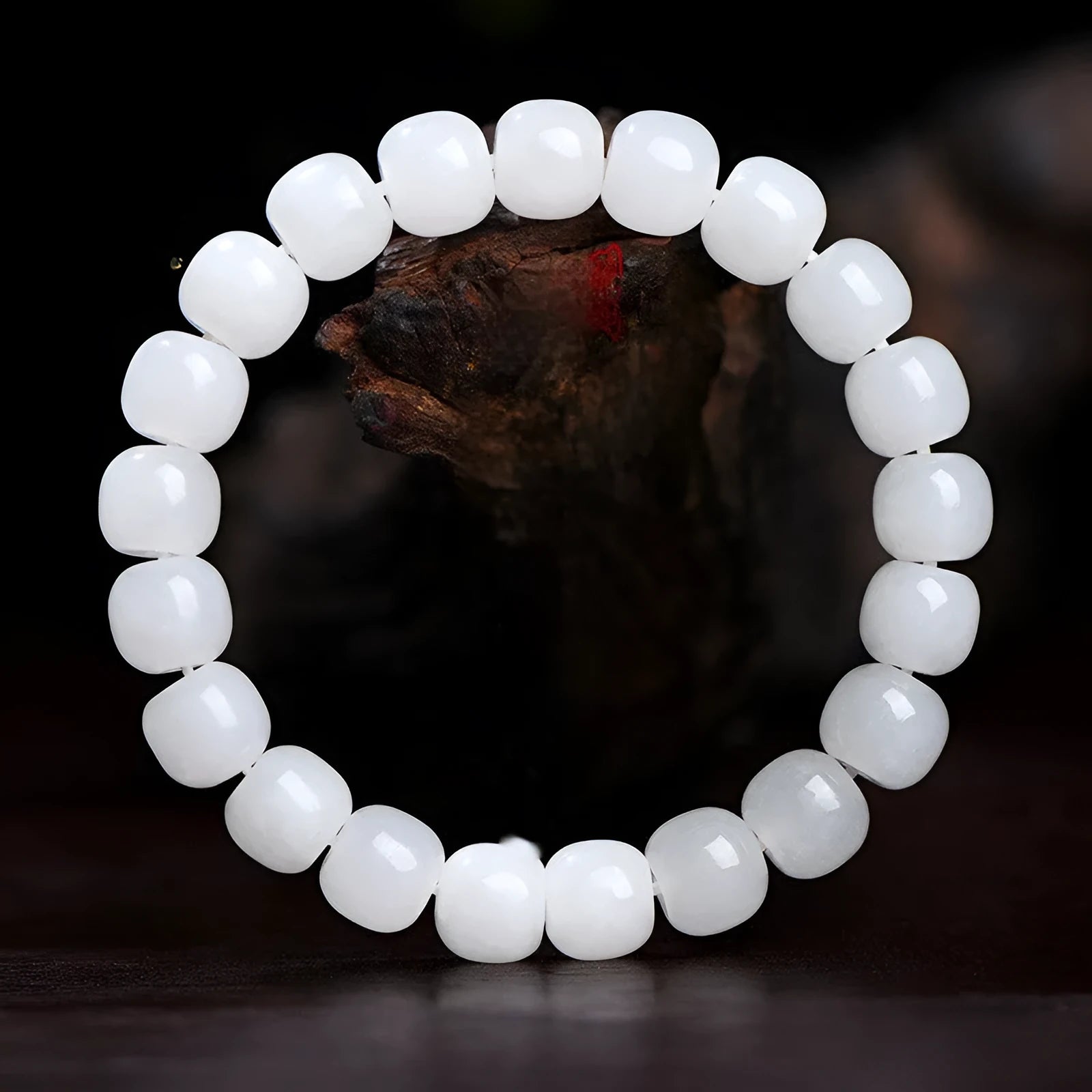 White Hetian jade barrel bead bracelet on a wrist, showing the smooth stone beads and unisex casual design.