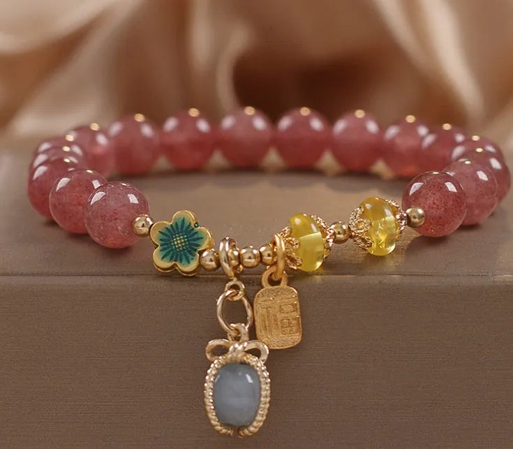 Red women's bracelet with natural strawberry quartz beads, alloy settings, and rhinestone decorative elements