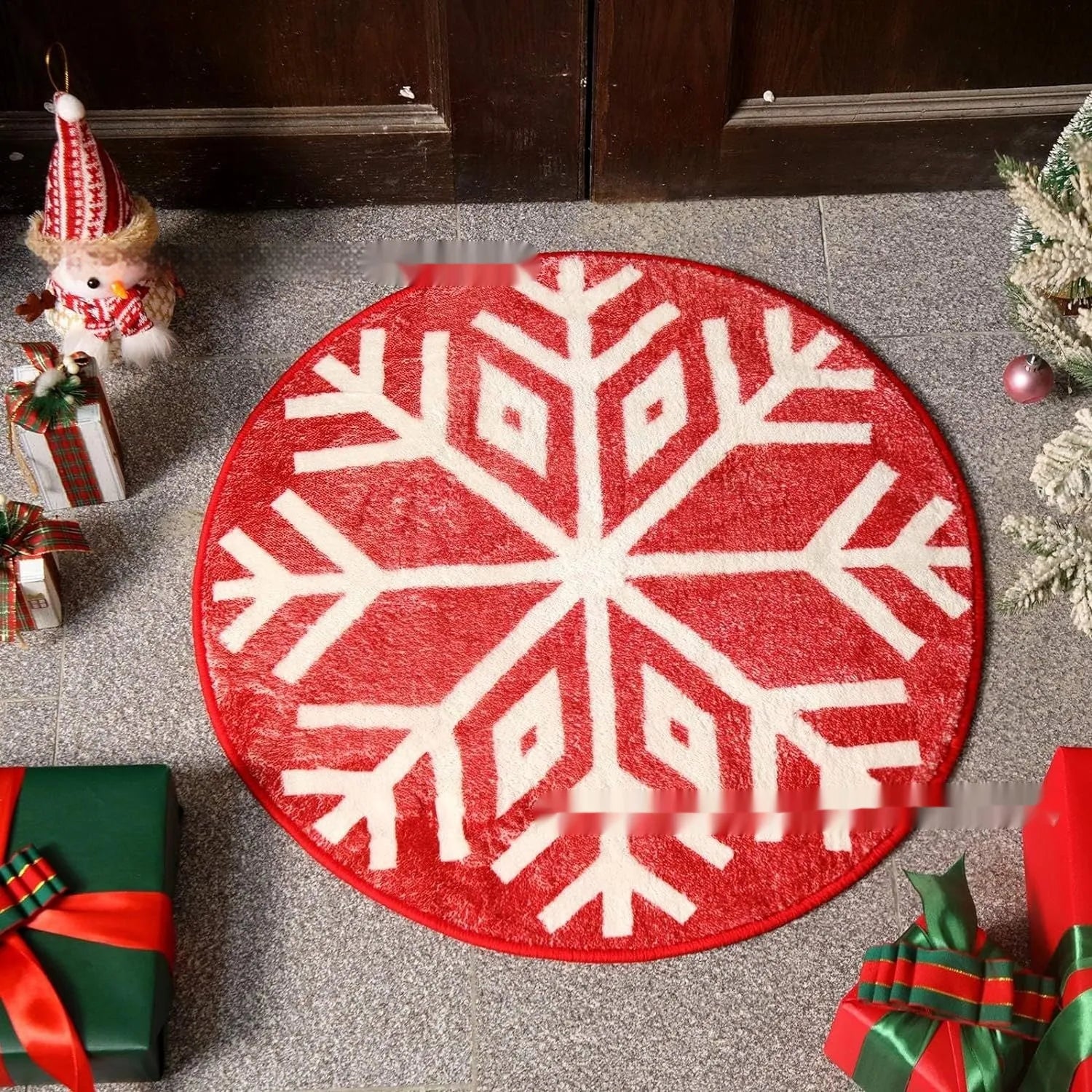 Round red and green Christmas pattern carpet on a wooden floor.