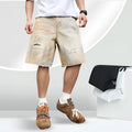 Men's light blue ripped denim shorts showing straight-leg design and mid waist fit
