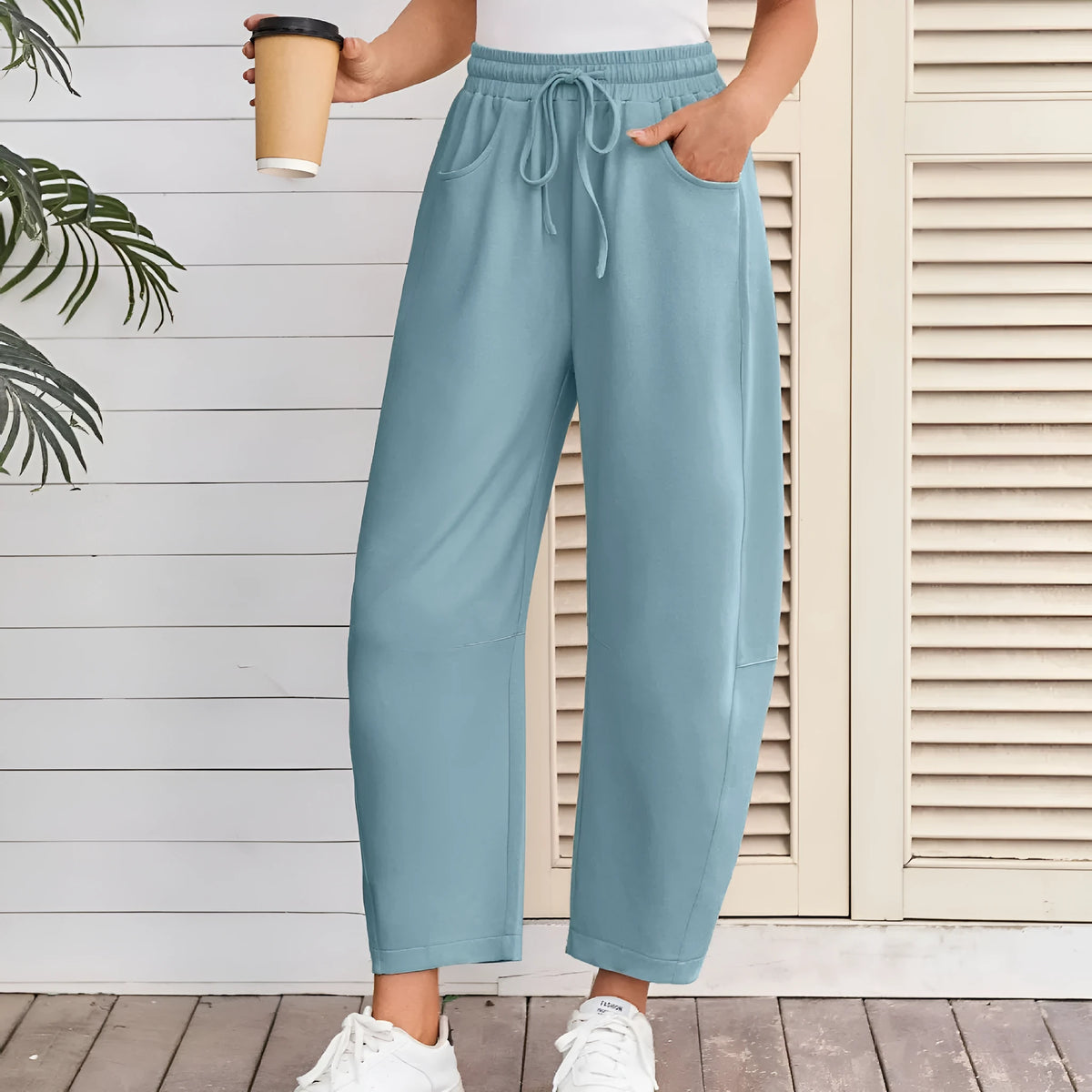 Loose cropped cotton sweatpants with drawstring waist and side pockets in street fashion style