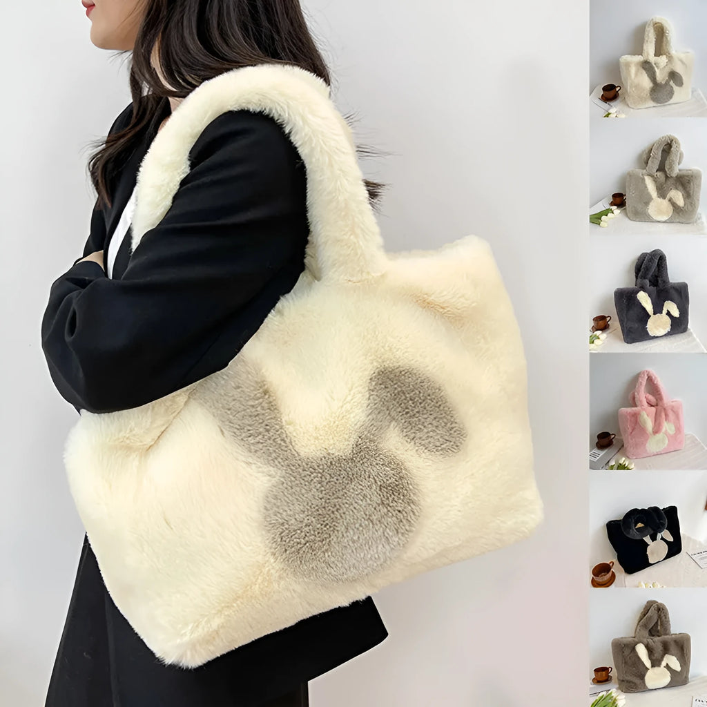 Plush shoulder bag with cartoon rabbit ears design in a solid colour.