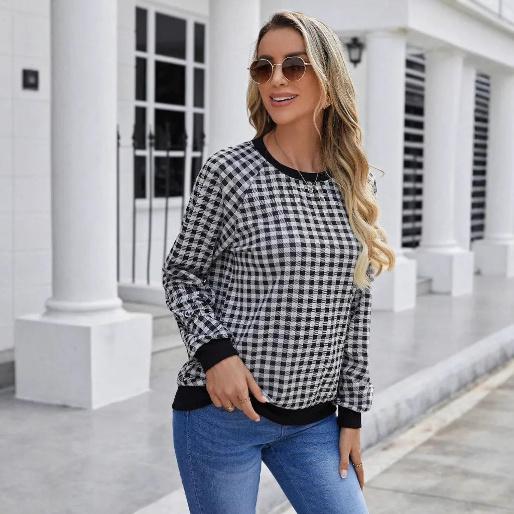 Black long sleeve pullover sweater with plaid stripes and printed pattern on a mannequin.