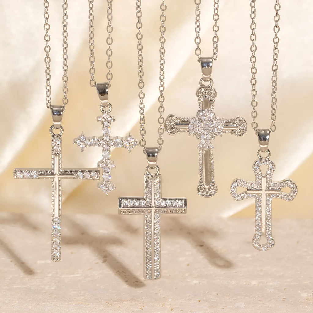 Gold electroplated copper cross necklace with micro inlaid zircon on a 41-50cm O-ring chain.