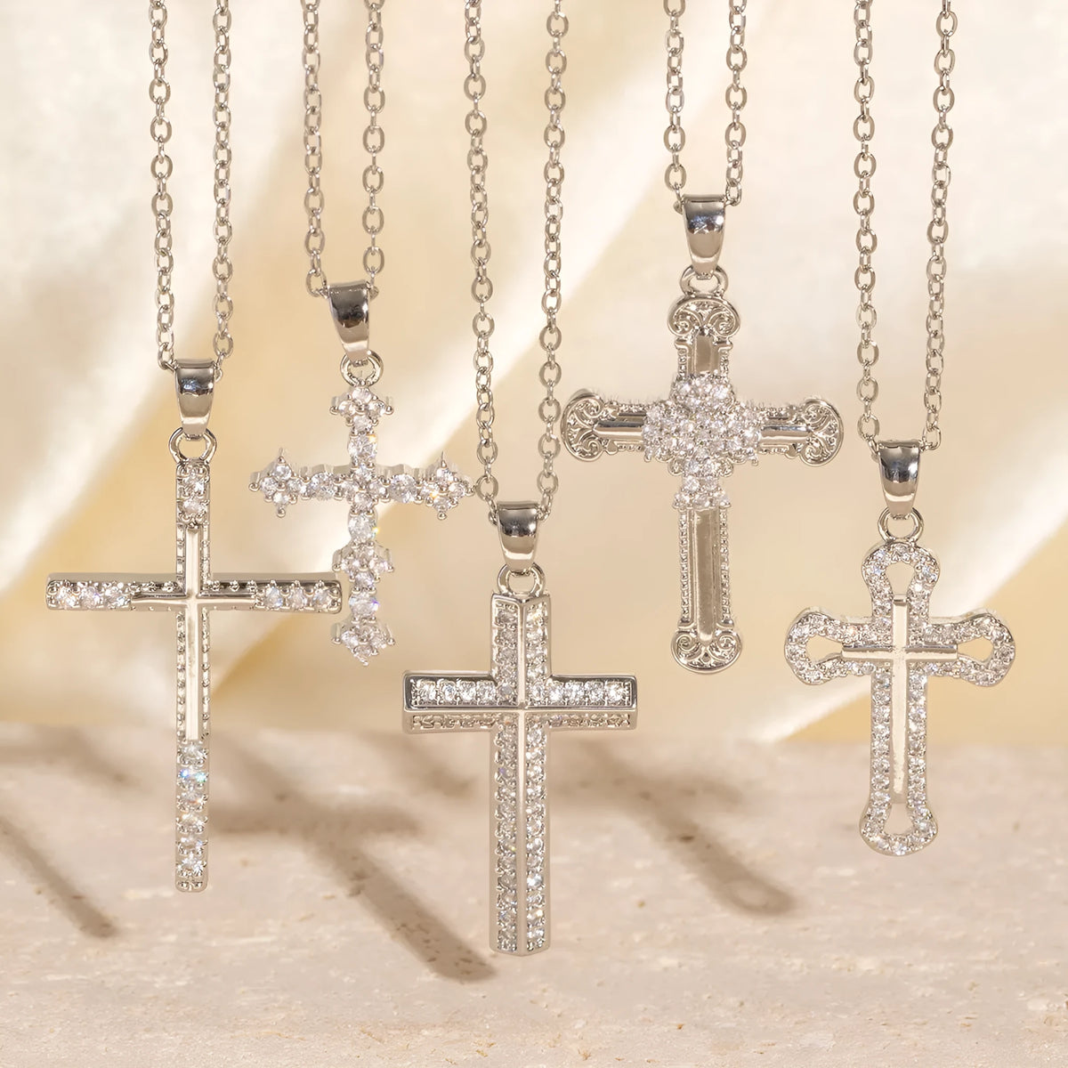 Gold electroplated copper cross necklace with micro inlaid zircon on a 41-50cm O-ring chain.