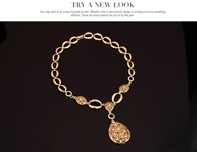 Gold alloy four piece jewellery set including necklace earrings bracelet and ring with bamboo link chain and love water drop bell patterns