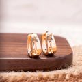 Rose gold U-shaped hollow carved women's earrings made from electroplated copper, one pair.