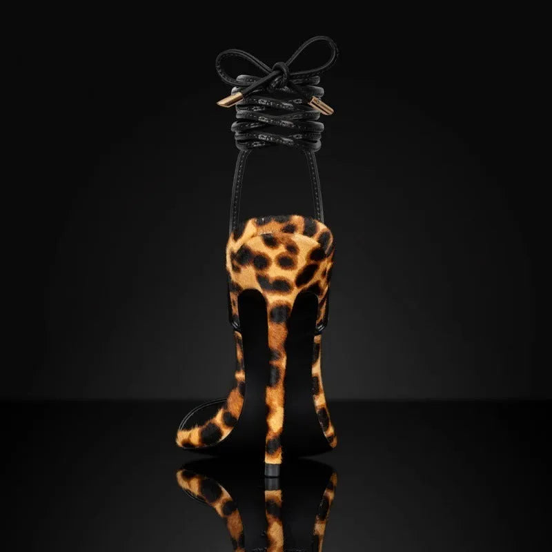 Women's leopard print Roman sandals with pointed toes and a buckle lace-up strap.
