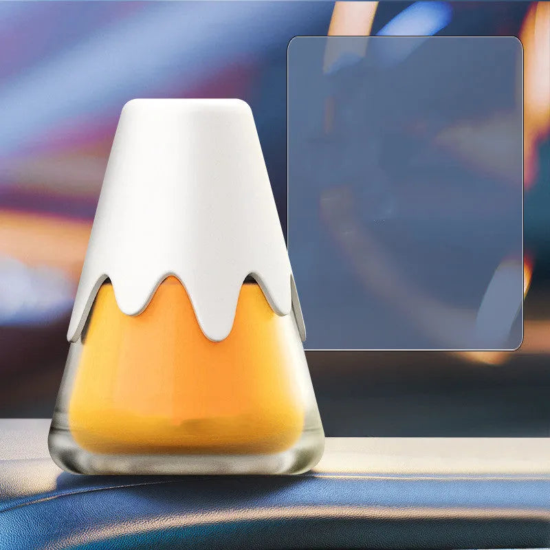 Refillable glass car aromatherapy unit in one of four colour options, showing compact size for dashboard or vent mounting.