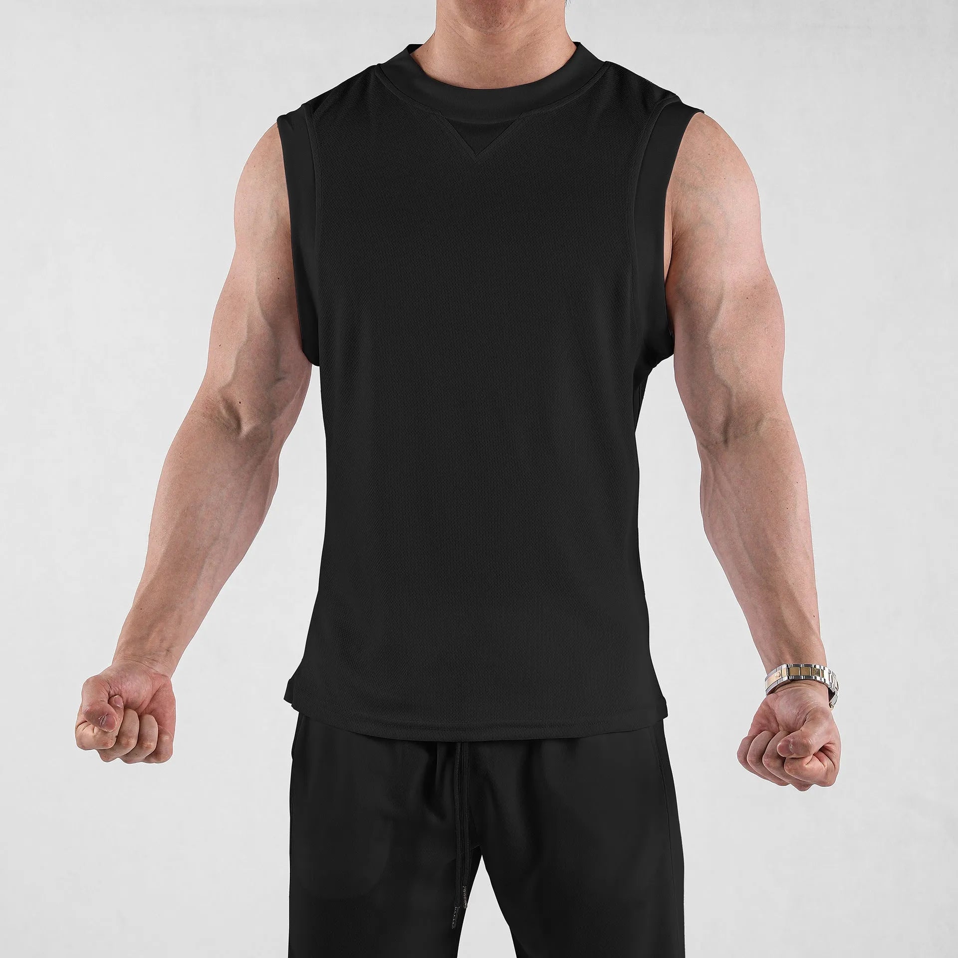Men's loose fit sports vest in white or black, made from soft polyester blend fabric.