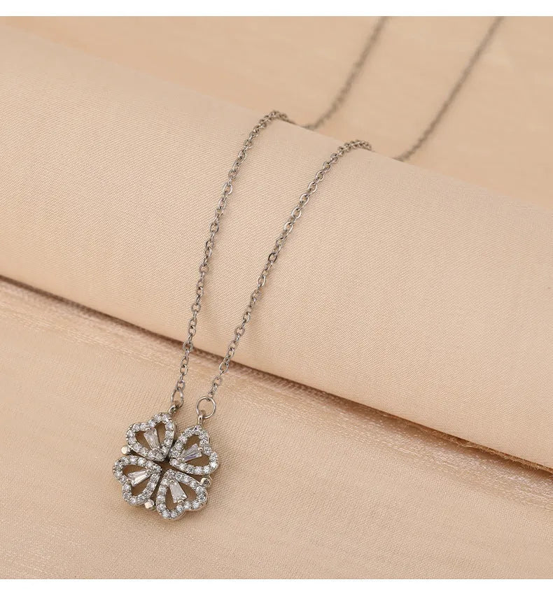 Four-leaf clover titanium steel necklace with diamond inlay pendant, gold finish, 42+6cm chain on light background