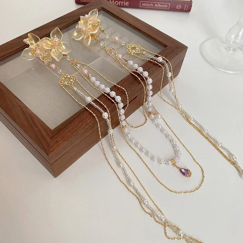 Gold-colour acrylic hairpin with pearl and diamond elements and long tassel design