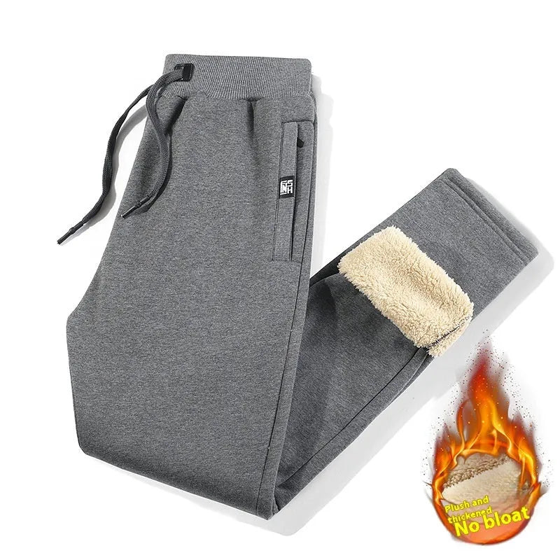 Men's grey fleece-lined oversized track pants with elastic waistband and straight leg design