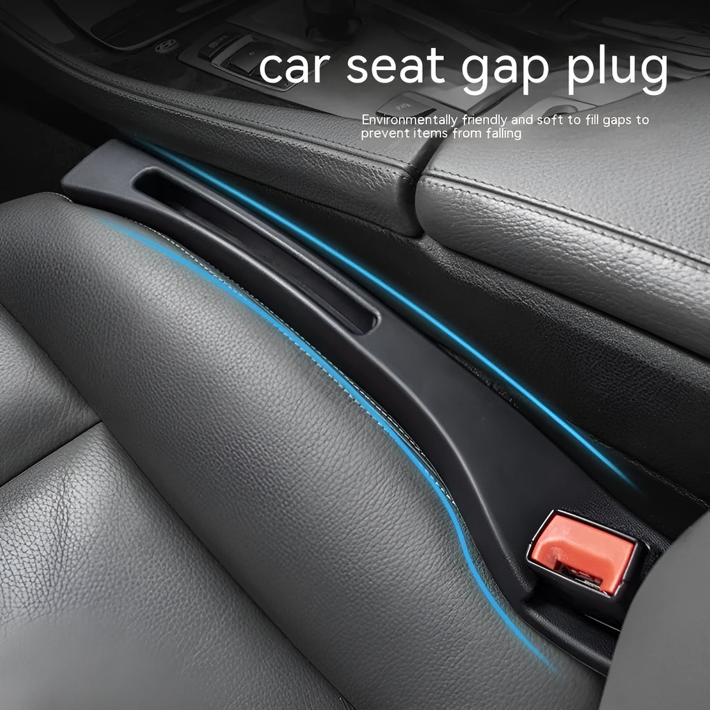 Black plastic car seat gap storage box with handle inserted between car seats.