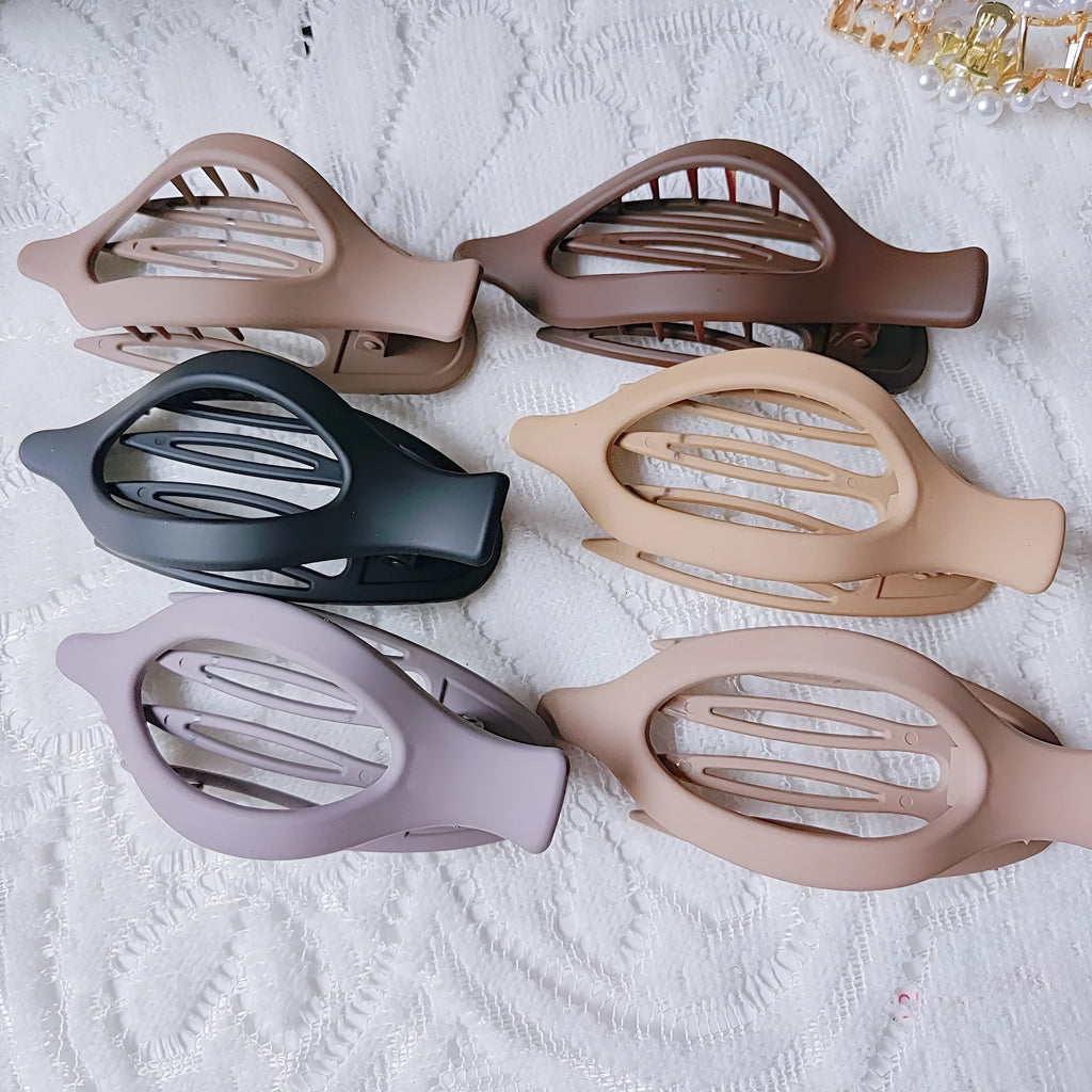 Six nude plastic hair clips with frosted finish and pointed toe quadrilateral design