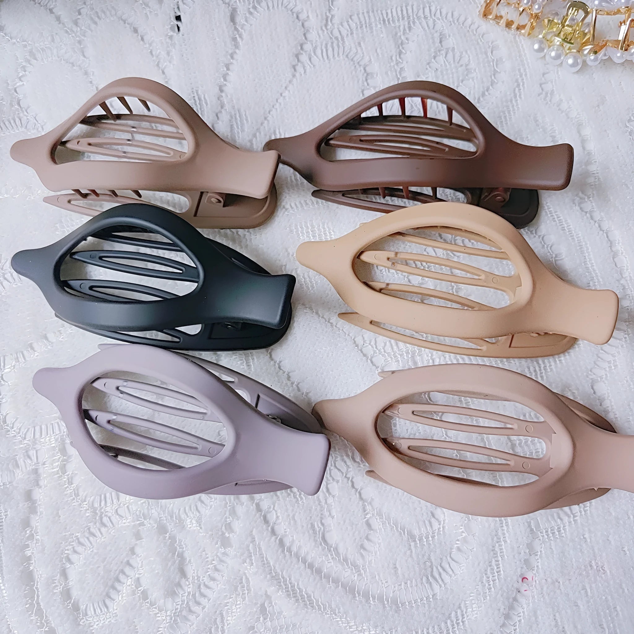 Six nude plastic hair clips with frosted finish and pointed toe quadrilateral design