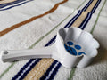 PLA cat paw pet food scoop in white and blue colour on surface