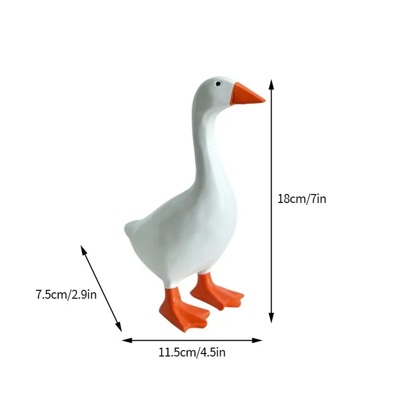 White simulated duck magnetic resin ornament on a fridge door