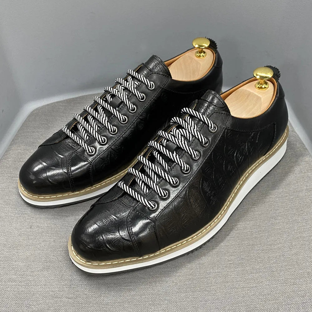 Men's black low-top sneakers with an embossed pattern and white laces.