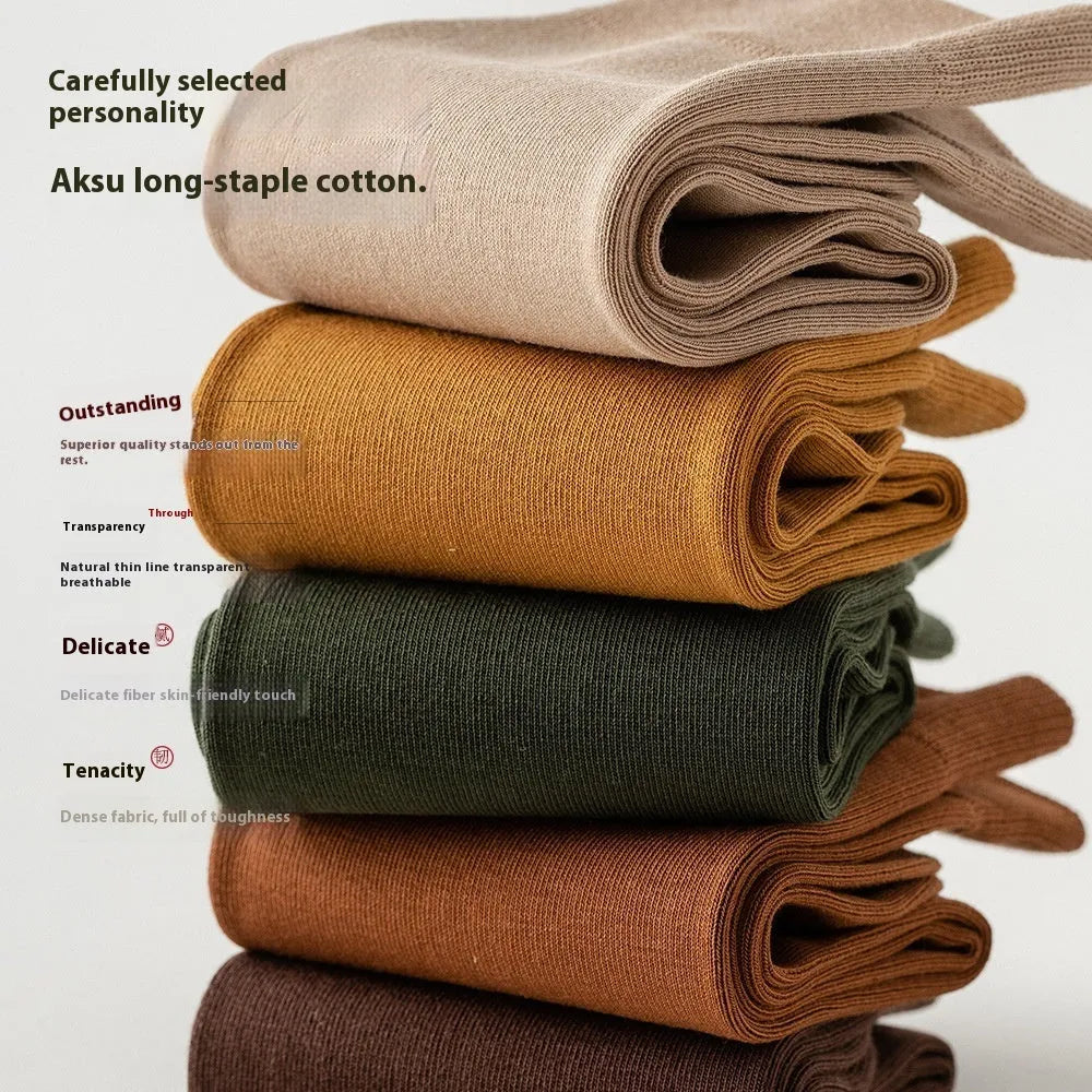 Men's solid colour mid-calf socks in combed cotton, shown in a range of neutral shades including beige, black, and dark blue.