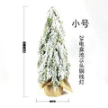 24-inch desktop artificial Christmas tree with LED lights and white snow finish on plastic branches