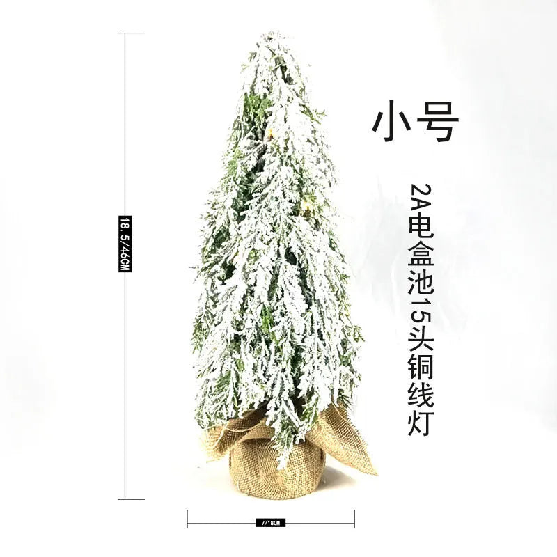 24-inch desktop artificial Christmas tree with LED lights and white snow finish on plastic branches