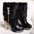 Women's black ankle boots with a chunky high heel on a white background