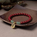 Traditional handmade gold cinnabar wave bracelet with copper bead accents in pumpkin or brand cinnabar colour options