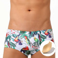 Men's navy blue swimming trunks with colourful flower and bird print pattern.