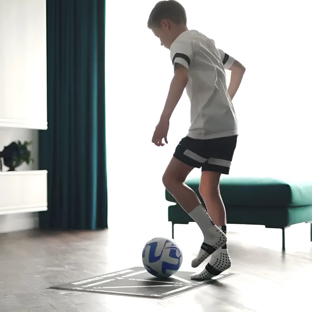 Black non-slip football training mat measuring 60 by 90 centimetres.