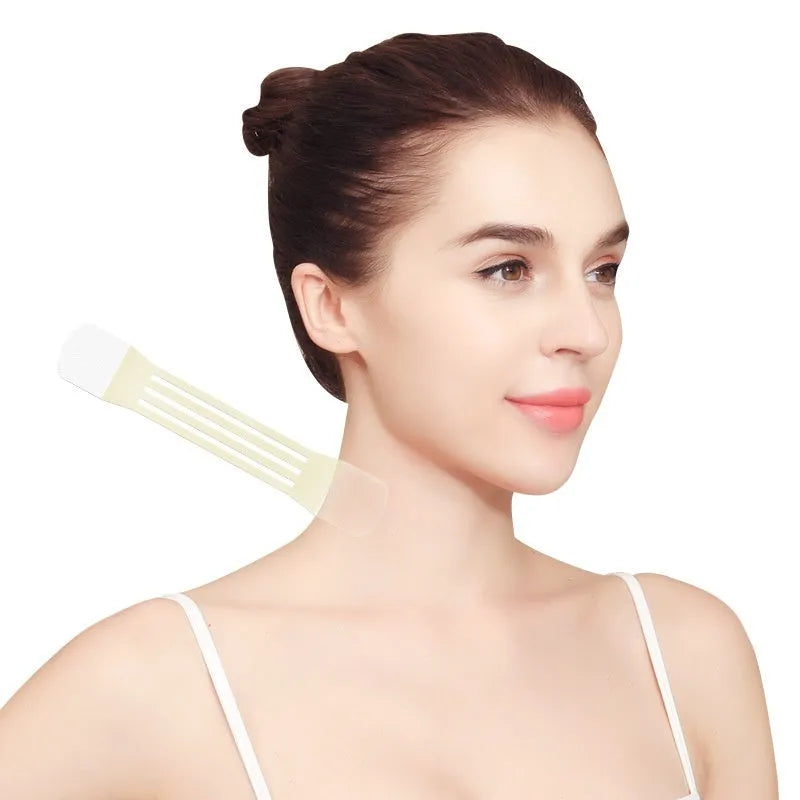 Skin tone neck firming adhesive patches and V27 pattern sling laid out on table