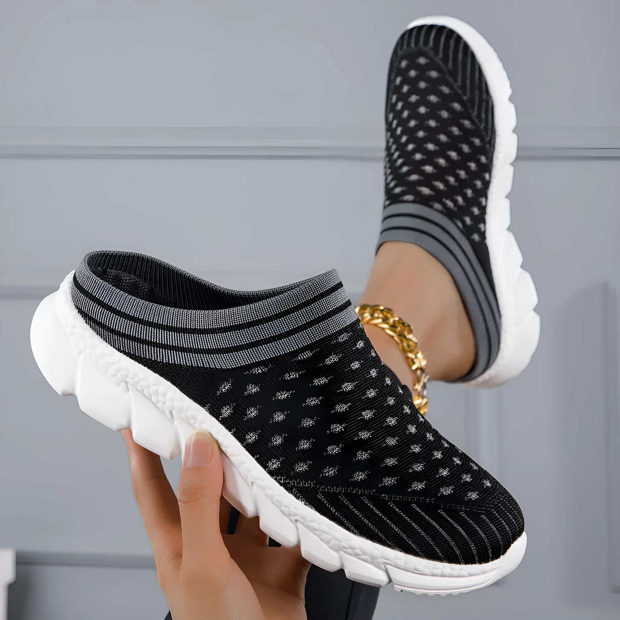 Women's black Flyknit semi-slipper shoe with striped pattern and raised sole