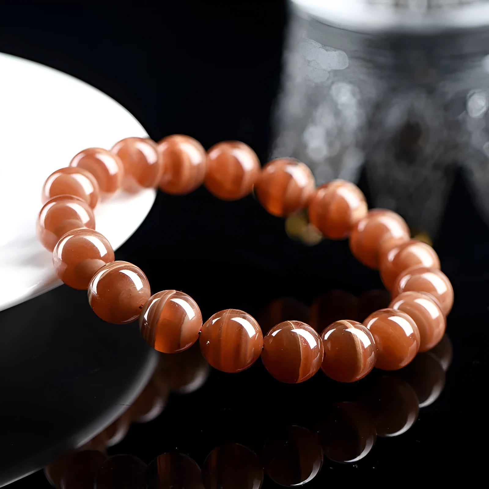 Natural pink old mine rhodochrosite round bead bracelet with a silver Ruyi charm.