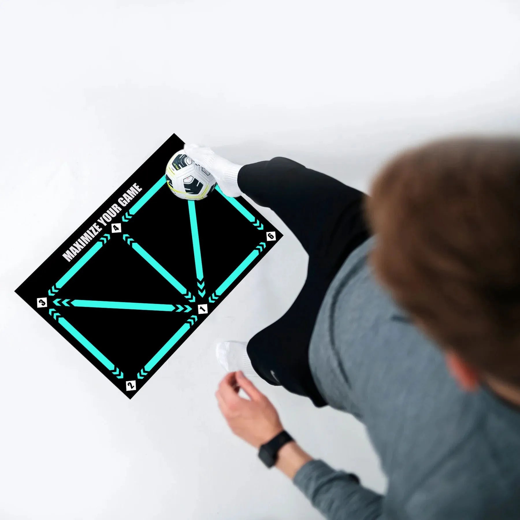 Black non-slip football training mat measuring 60 by 90 centimetres.