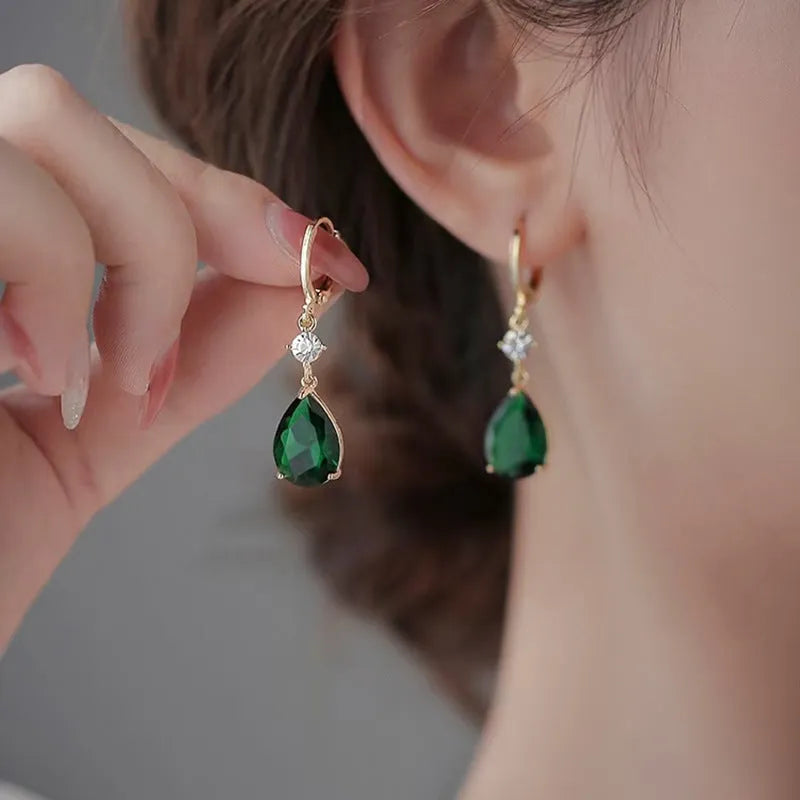 A pair of green geometric teardrop-shaped alloy earrings.