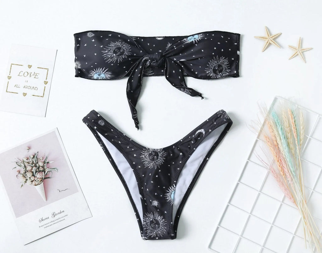 Black bikini print one-piece swimsuit with backless, split tube top design for women.