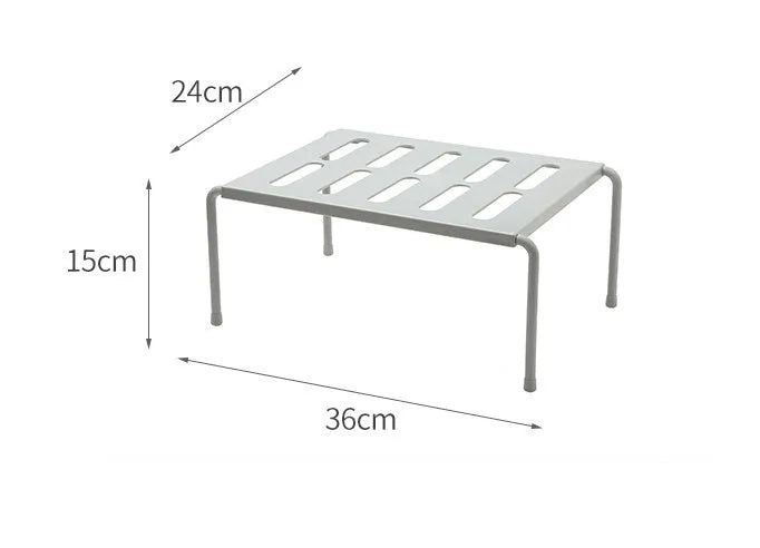 White telescopic plastic kitchen rack extended to 69cm height on kitchen countertop