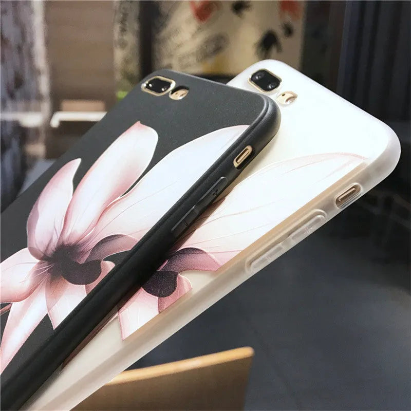 Black and white iPhone TPU cases with a raised embossed floral pattern on the back.